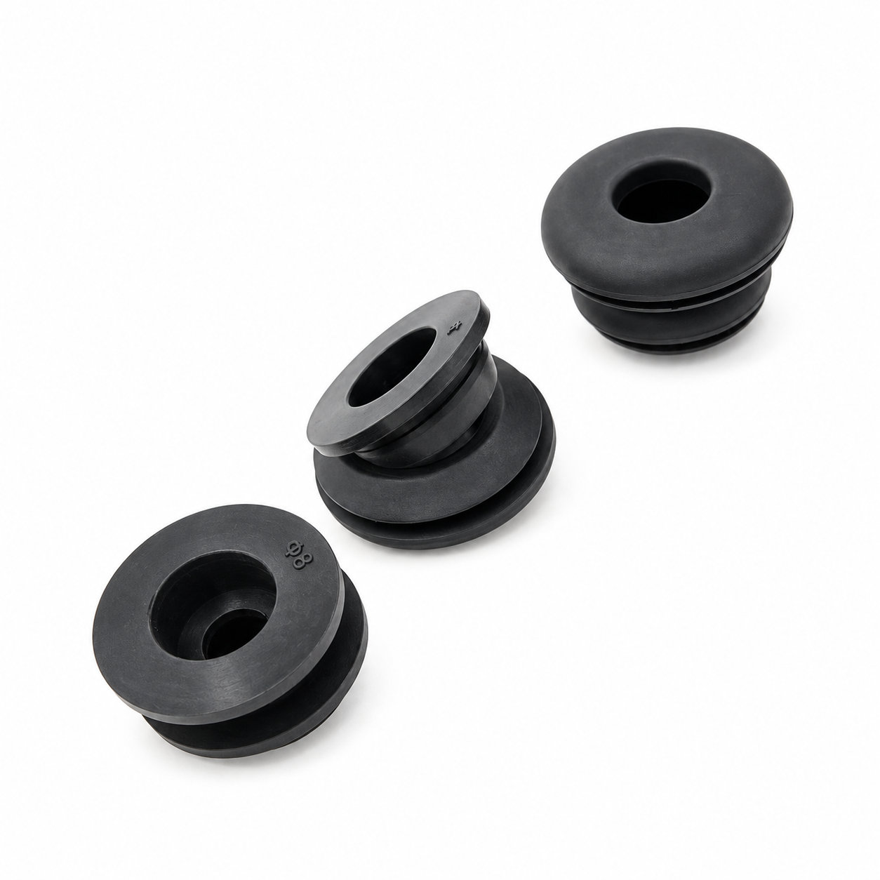 Molded rubber wiring harness grommets for machine